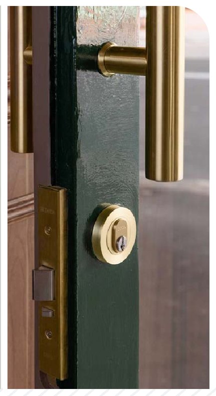 Deep green entrance door with a brass pull handle and keyed cylinder